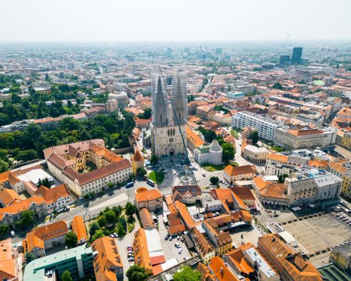 Aerial drone view of Zagreb, Croatia. Historical city centre with multiple old buildings made in national style, Zagreb Cathedral, greenery