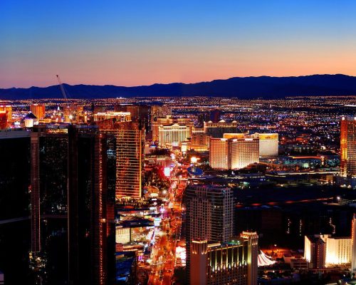 Las Vegas City Skyline panorama with sunset, mountain, luxury hotels and streets.