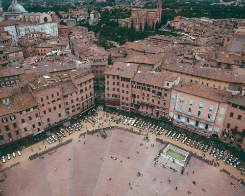 Siena, Italy - June 28, 2018: Panoramic view of Piazza del Campo is the principal public space of the historic center of Siena from Torre del Mangia is a tower in city