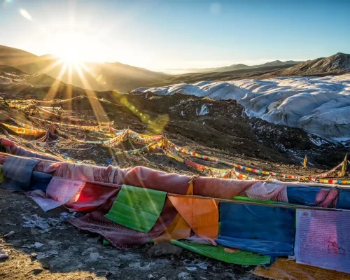 Assorted-color Flags on Mountain during Sunrise