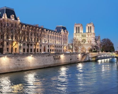 Eveing panorama of illuminated Paris with Notre-Dame cathedral