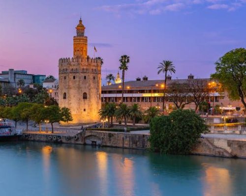 Famous watchtower Golden Tower or Torre del Oro and River Guadalquivir at sunset, Seville, Andalusia, Spain